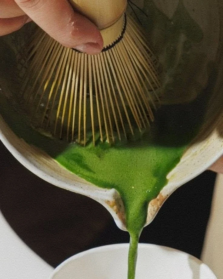 Fresh matcha being poured from a ceramic bowl